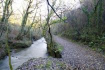 RAILWAY BED EMBANKMENT ALONG RIVER AT CWM CLYDACH