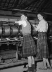 Models wearing a tartan skirt and kilt, Dinas...