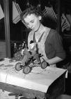 Woman worker at the Lines Bros. toy factory,...