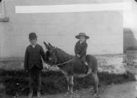 A boy riding a donkey, Pembroke, c. 1885