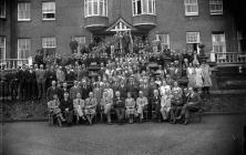 Group photograph of men and women outside the...