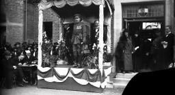 Photograph of military officer on dais,...