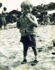 Boy eating ice cream on the beach