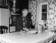 Mrs Jane Jones standing beside table with bara...