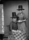 Two women in national dress drinking tea (Mellor)