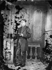 young man standing and reading a book