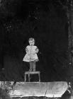 child standing on a chair