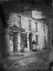 Two women standing outsied a grocer's shop