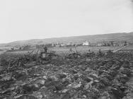 Line of tractors ploughing