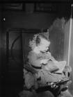 Boy sitting in a chair reading a book