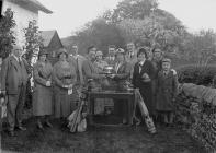 Group photo with a woman being presented with a...