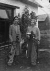 Two lady golfers with clubs, one holding a trophy