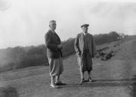 Two men on the tee of a golf course