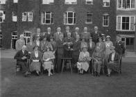 Group of men and women at a presentation of...