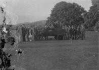 Group of people on a golf course with green...