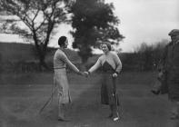 Two lady golfers shaking hand