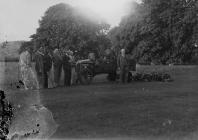 Group of people on a golf course with green...