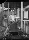 Lady holding a cup outside Llandrindod Wells...