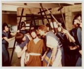 Young men in costume perform with crosses