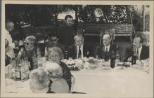 Group of people eating a meal in the sun