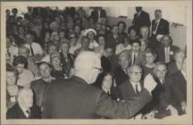 Large group of people seated in a hall