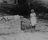 Mary Jane Lewis carrying water from the well,...