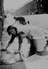 Washing the pavement, 1930's