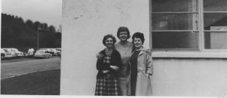 Sylvia Reardon standing outside factory with 2...