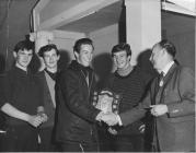 Bill Moses with sports trophy in the factory.