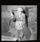 Quarryman splitting a large piece of slate