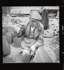 Quarryman splitting a large piece of slate