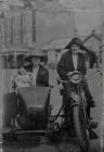 Two ladies on a motobike and sidecar.