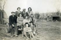 A group of Land Army women with farmers