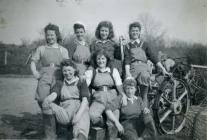 Land Army women using a threshing machine