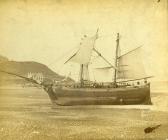 A merchant ship with a broken top mast beached...