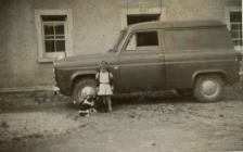 Car and child in front of Glynsaithmaen...