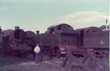 Old steam trains at a scrapyard in Barry,...
